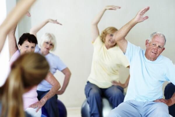 Caregivers assisting senior citizens with healthy living